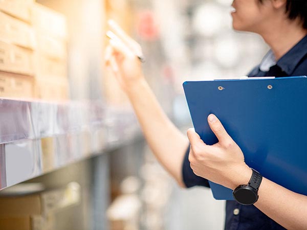 a person holding a clipboard doing inventory