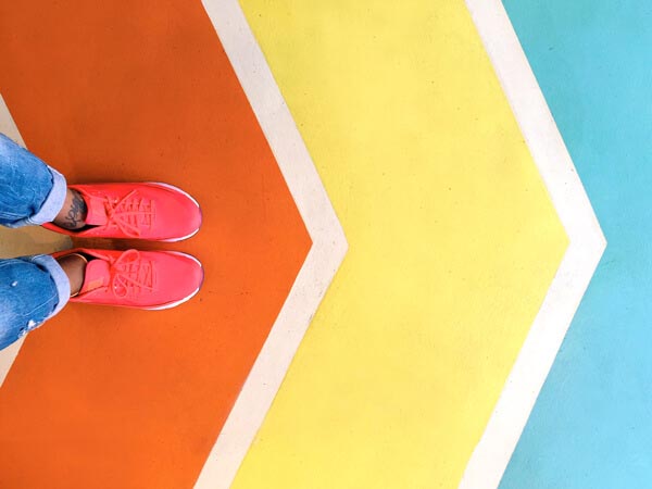 person standing on 3 colorful arrows