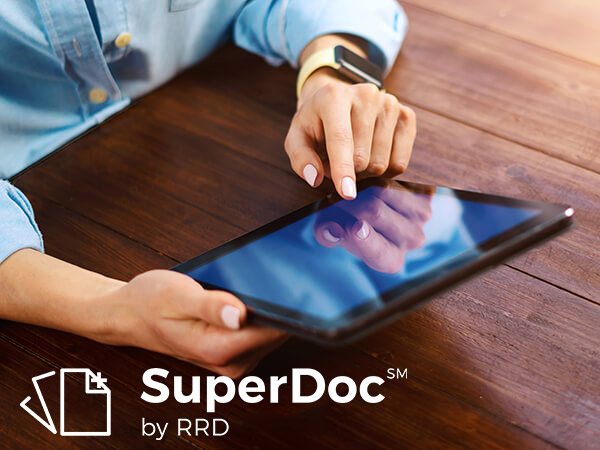 SuperDoc logo overlaying an image of someone using a tablet
