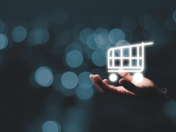 man holding a virtual shopping cart with dark blue speckled background