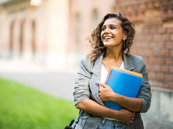 girl carrying textbooks