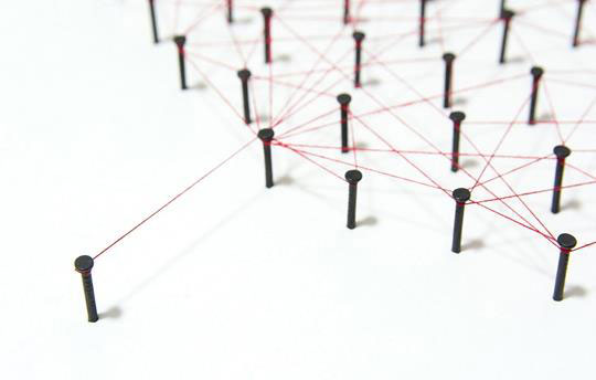 Thread wrapped around nails symbolizing growth