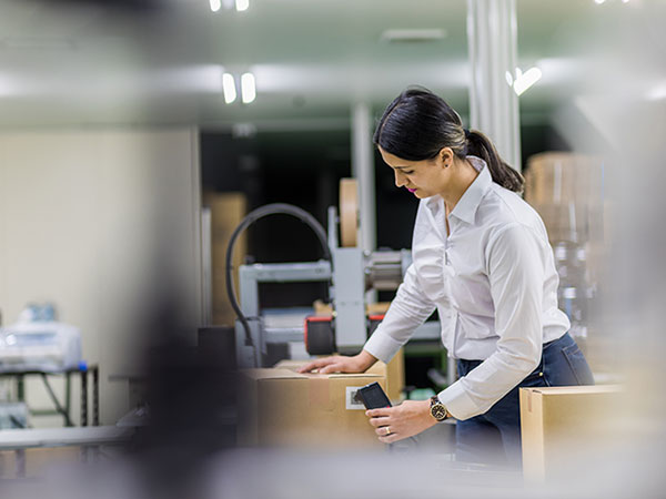 woman scanning shipping boxes