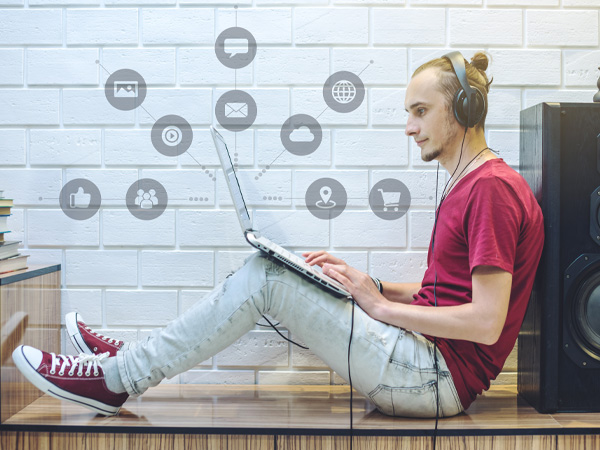 Guy on laptop with headphones on