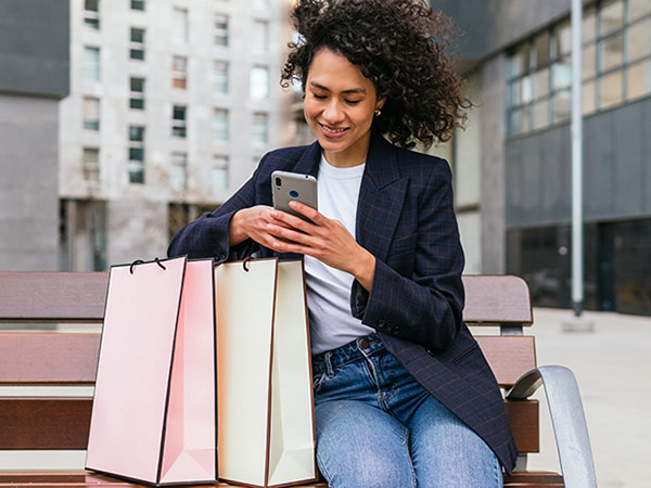 older woman using her smartphone while shopping