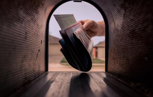 inside view of someone taking mail out of mailbox