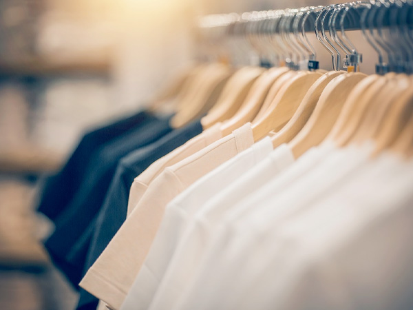 shallow focus shot of a line of tshirts hung up on a retail rack