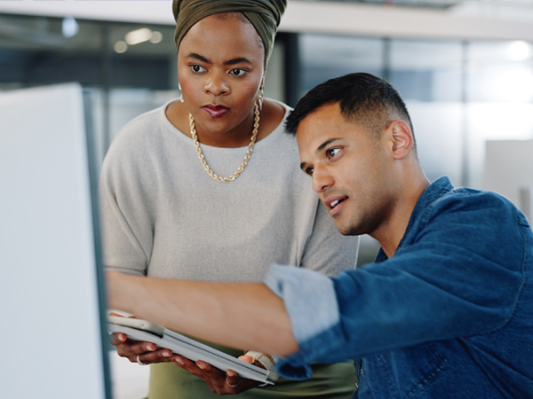 man and woman collaborating in office