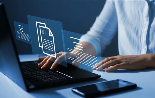 Businesswoman working on laptop with virtual screen.