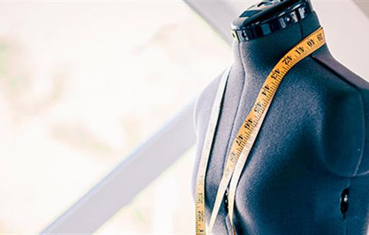 a tape measure draped over the torso of a sewing model