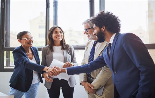 A franchise manager talking to two franchise operators