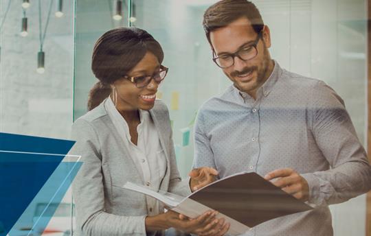 professional woman and man reviewing a document together