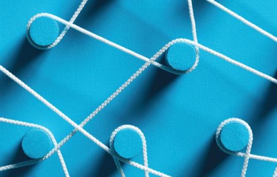 white string wrapped around blue pegs